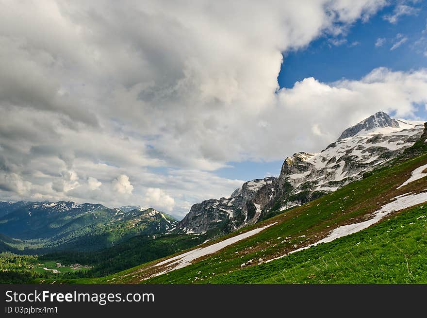 Snow and grass in the North Caucasus mountains. Russia.