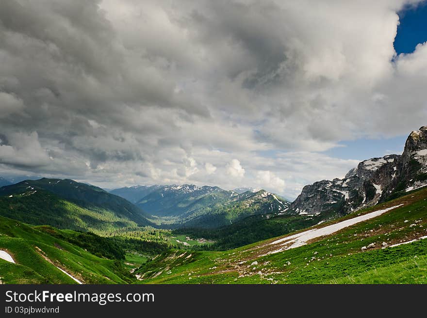 Snow and grass in the North Caucasus mountains. Russia.