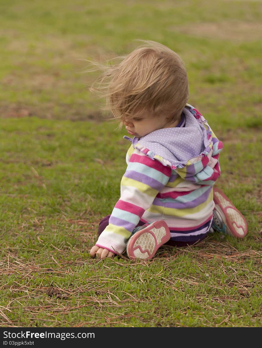 A momant captured as this curious toddler explores a park. A momant captured as this curious toddler explores a park