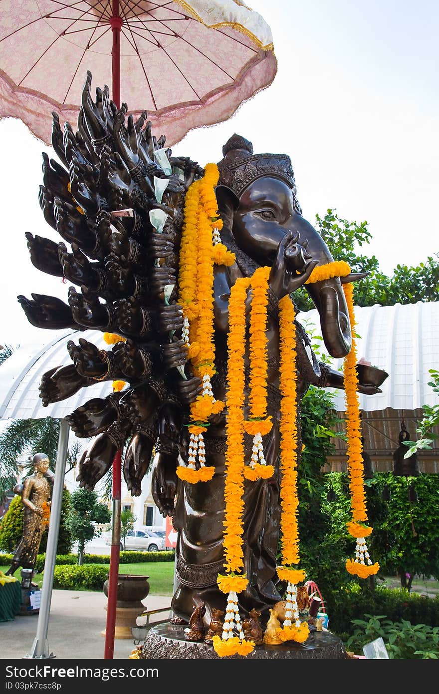 Many cast bronze hands of god Ganesha with yellow garland,Wat Samarn,Chacheangsoa,Thailand.