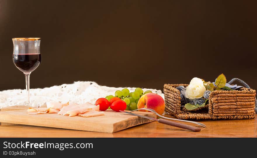 Dinner with ham, wine and fruit