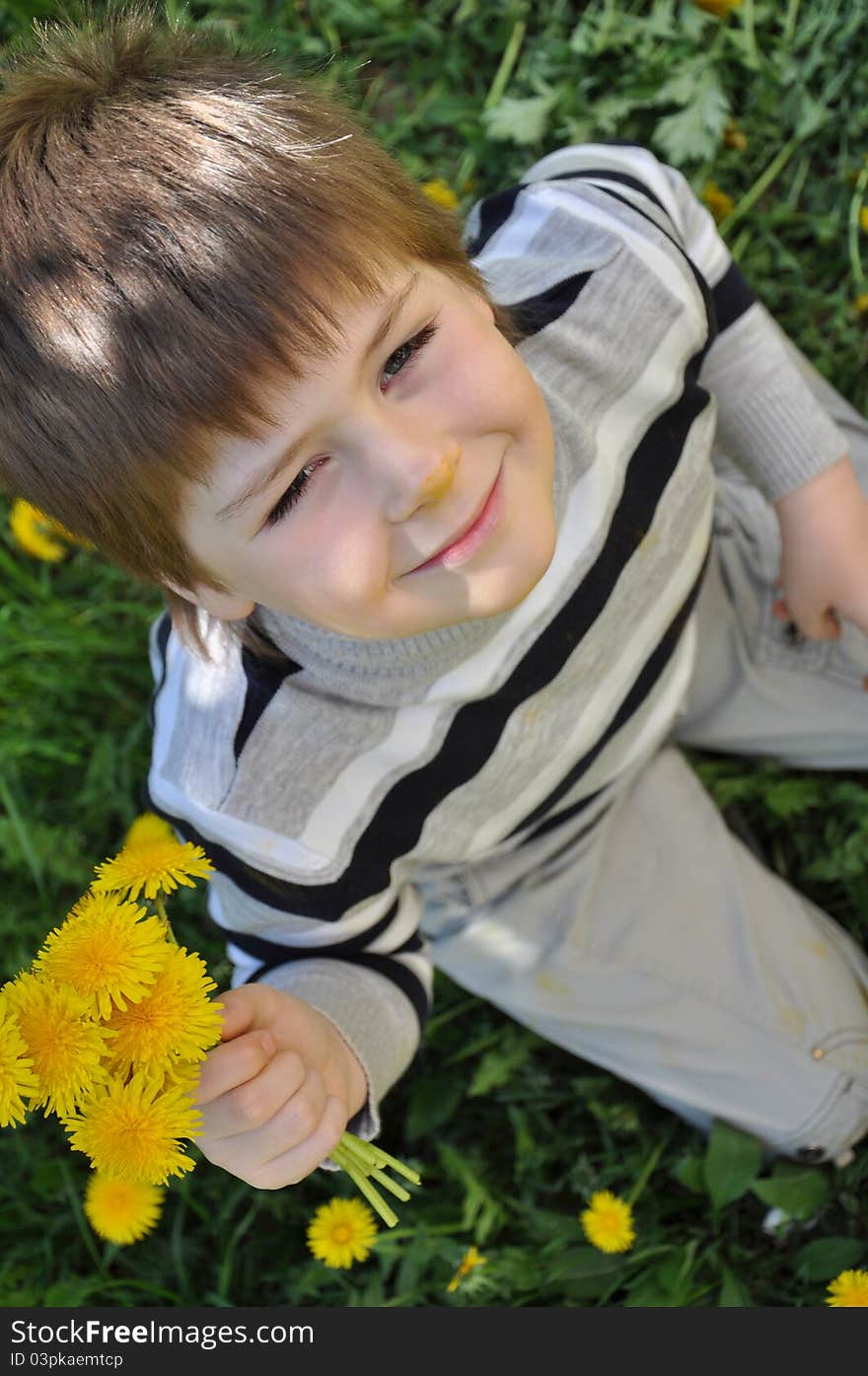 A boy with a  dandelions