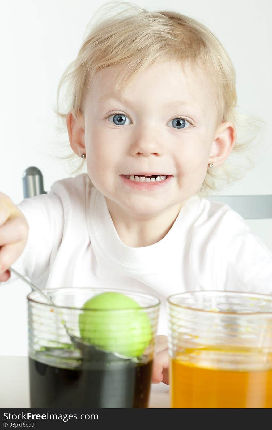 Little girl during Easter eggs'' coloration. Little girl during Easter eggs'' coloration