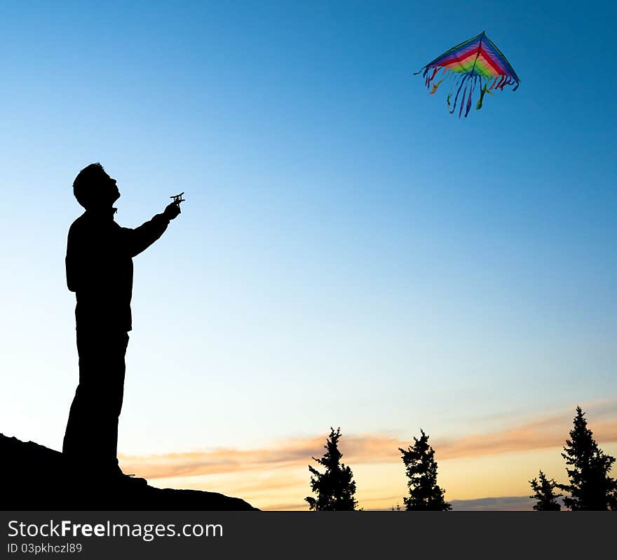 Young Man Isolated Flying A Rainbow Kite