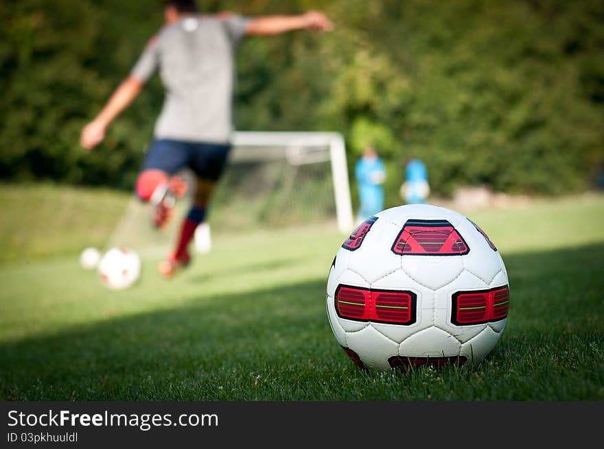 Ball and player on the grass. Ball and player on the grass