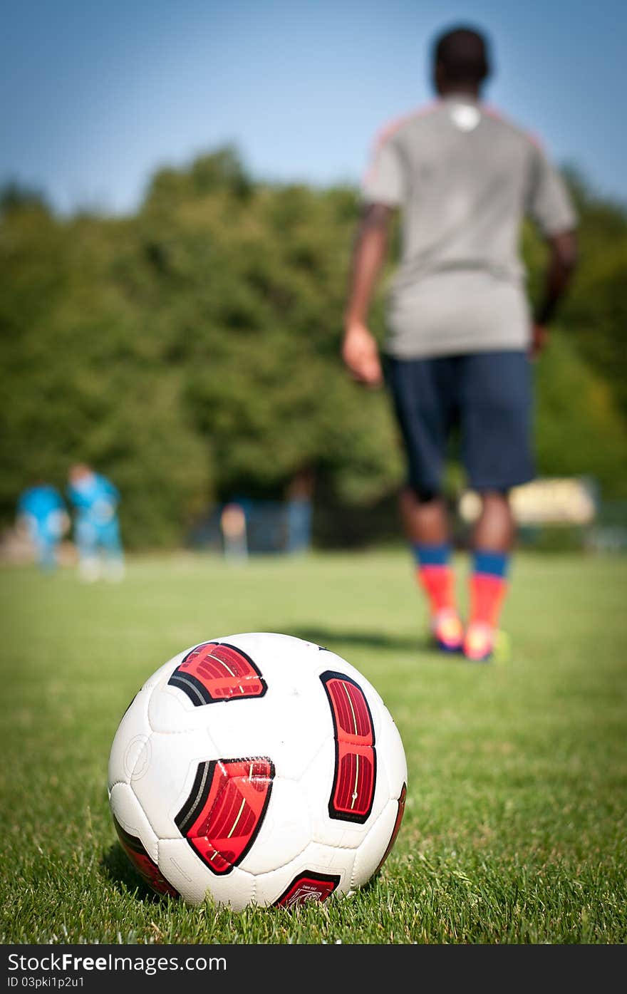 Ball and player on the grass. Ball and player on the grass