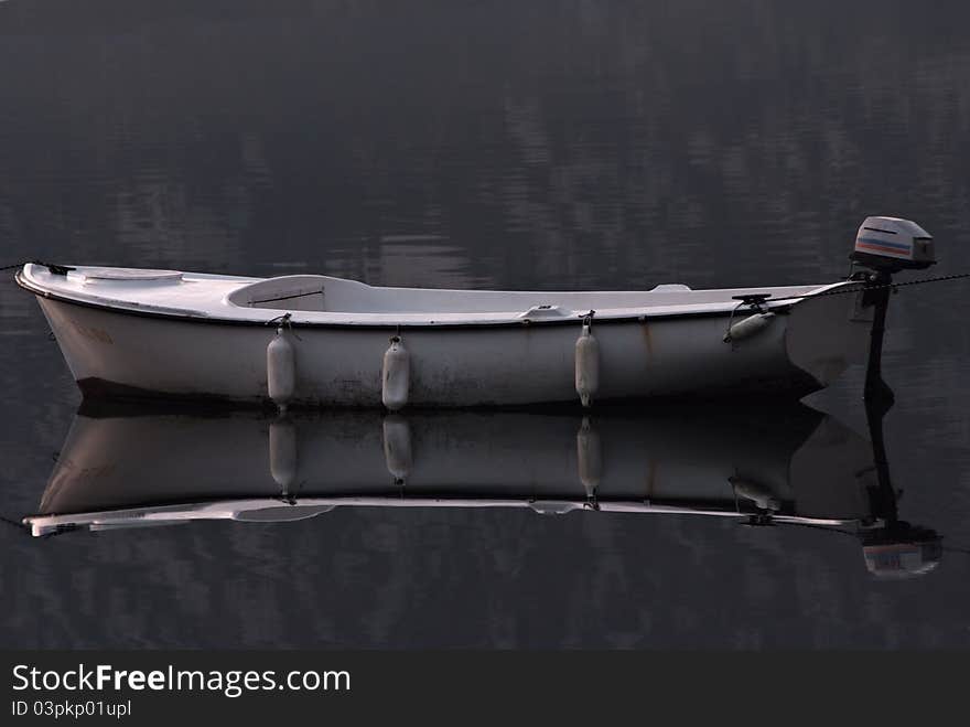 Old wooden fishing boat on calm water