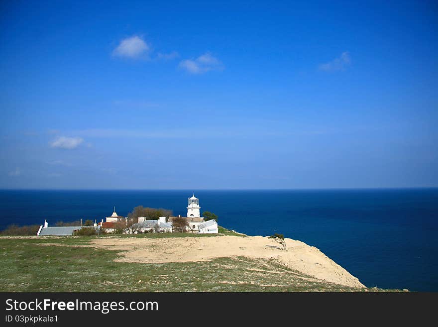 White lighthouse on a high sea coast