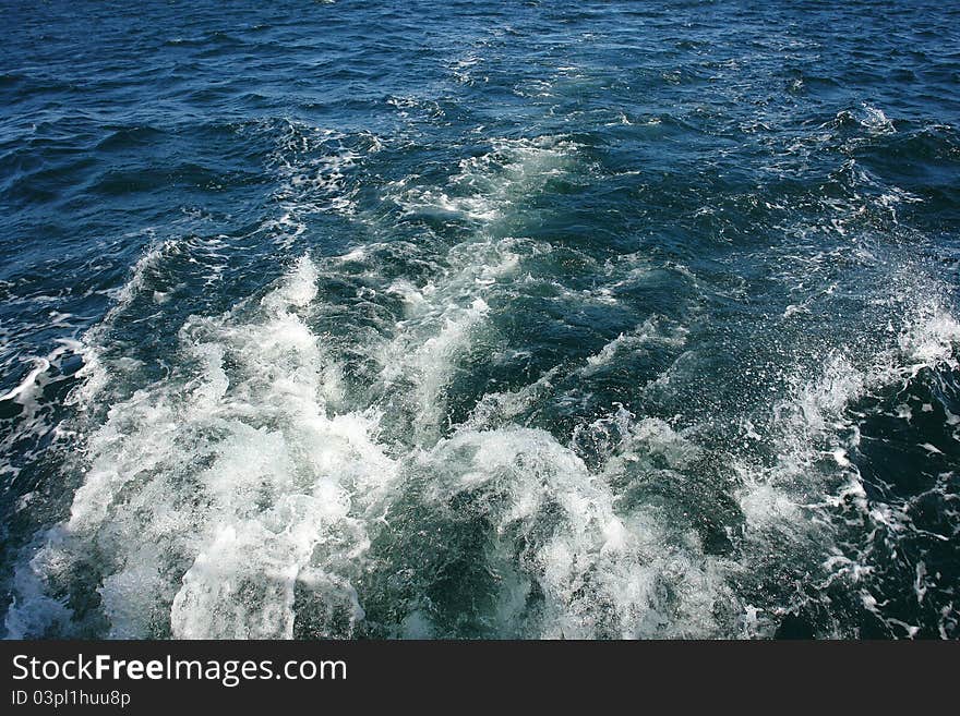 Large boat water wake trail left over the sea ocean - great boating sailing background