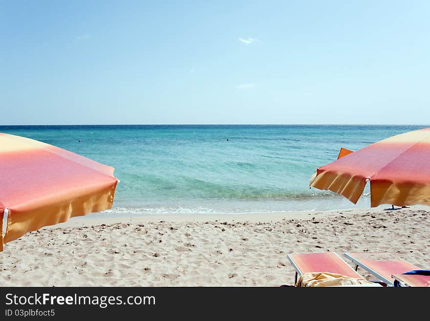 Two chairs and two umbrellas on the tropical beach. Two chairs and two umbrellas on the tropical beach