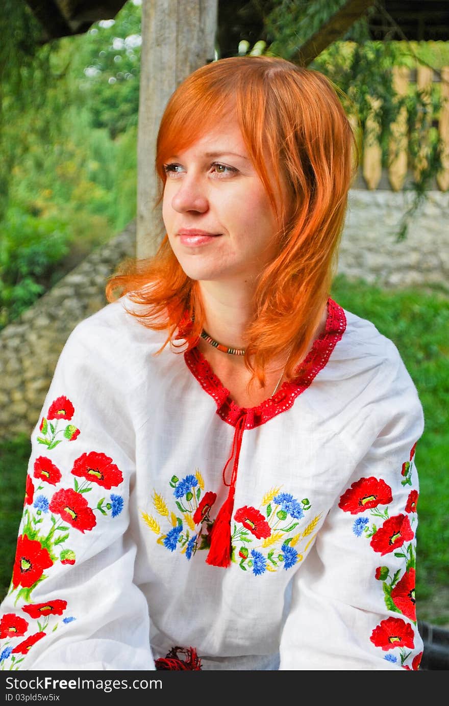 Beautiful Ukrainian girl in national clothes outdoors