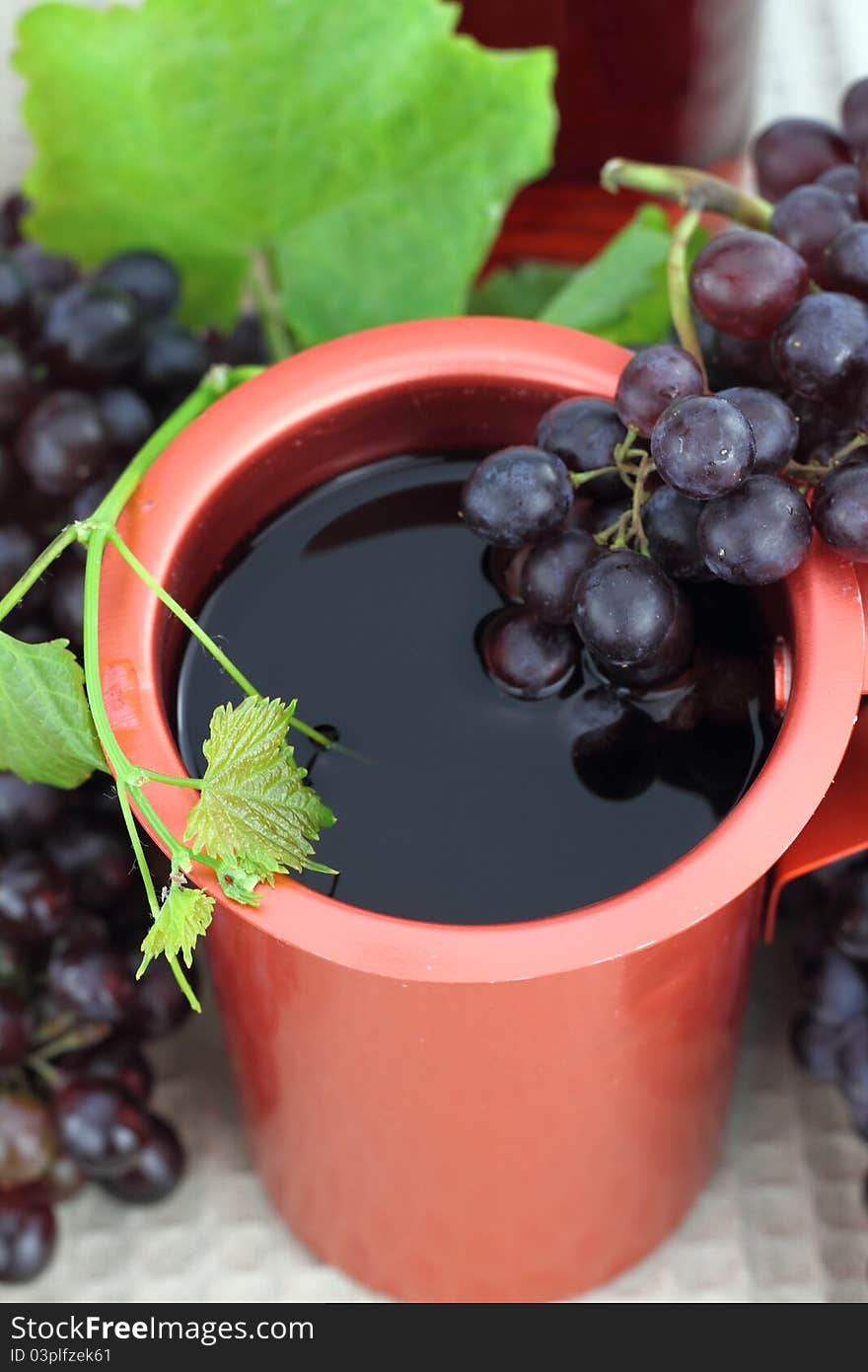 Red wine in a bronze jug