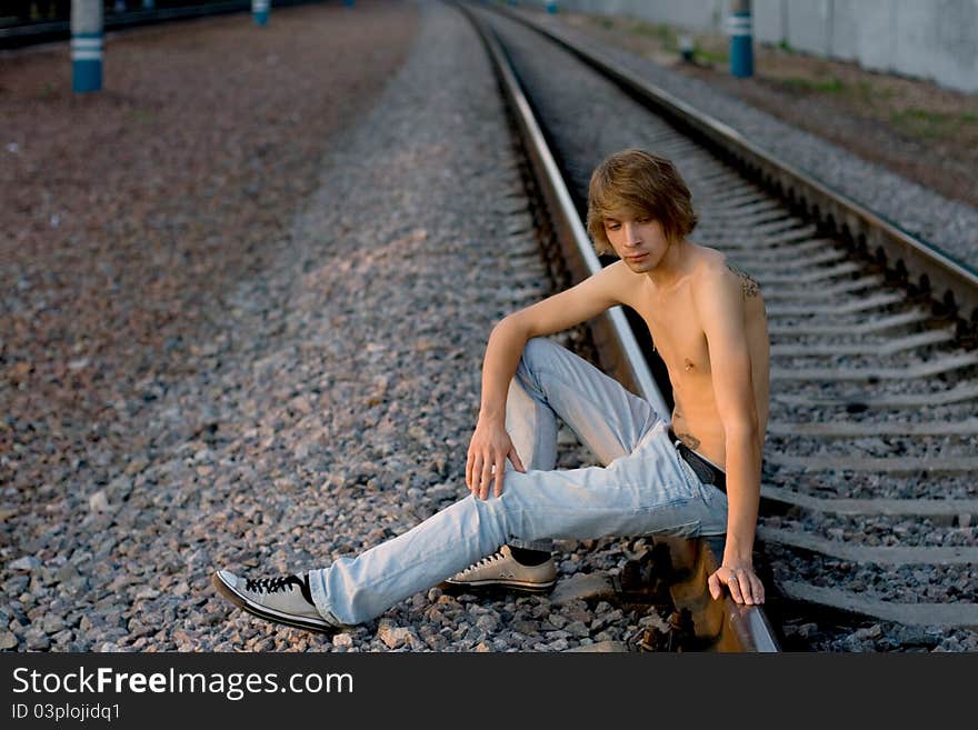 Handsome man walking near rails