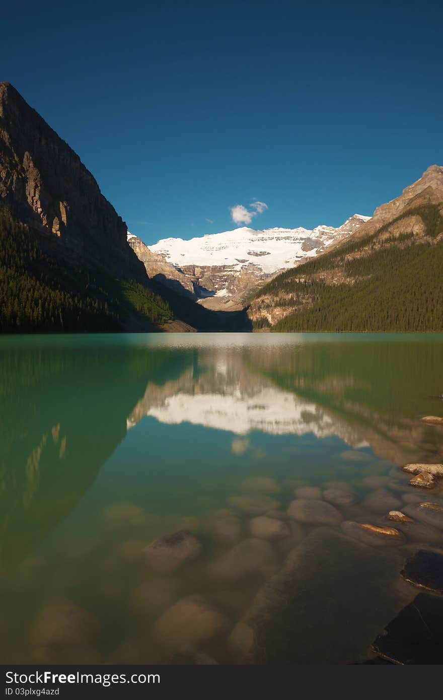 Morning on the Lake Louise, Banff (Alberta, Canada), in Rocky Mountains. This is a long exposure (up to 30 seconds) photograph, to add dreamy appearance to the reflections in the lake. To capture the whole dynamic range of the scene, the high dynamic range (HDR) technique was used. (No tonal mapping was applied - so the colors are all real.)
