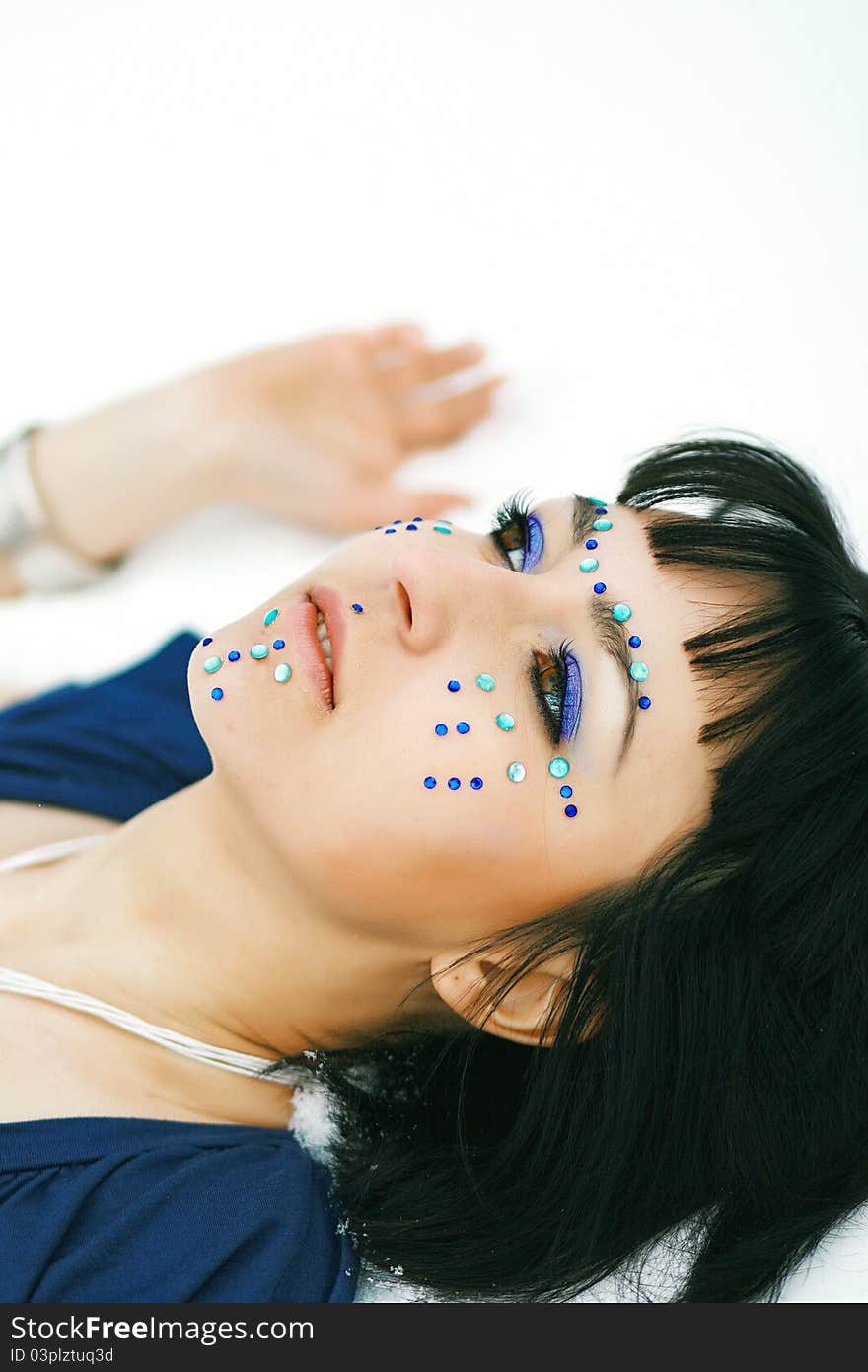 Model on a snow field with a bright make-up and pastes. Model on a snow field with a bright make-up and pastes.