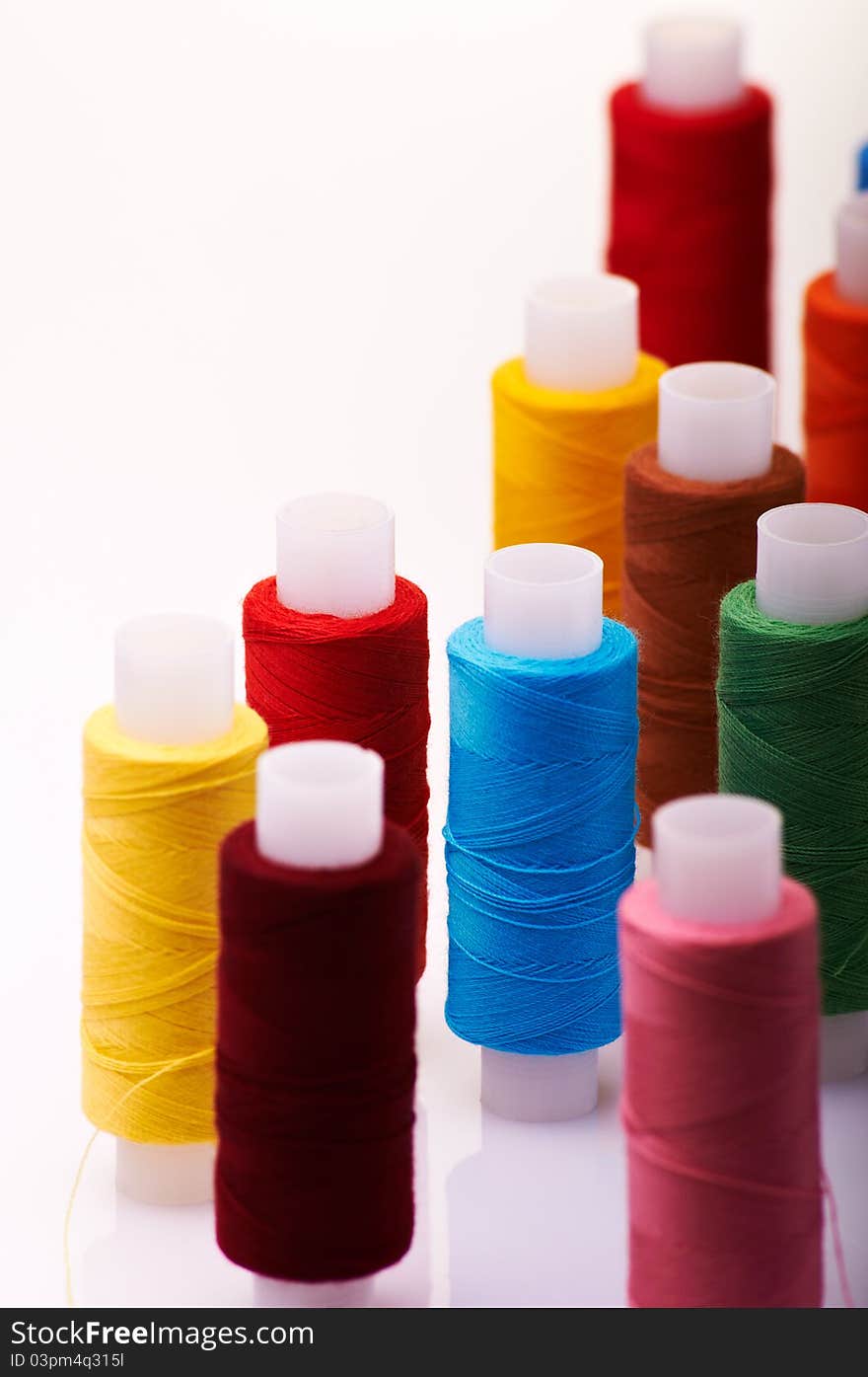 Multicolored spools of threads. Shallow depth of field.