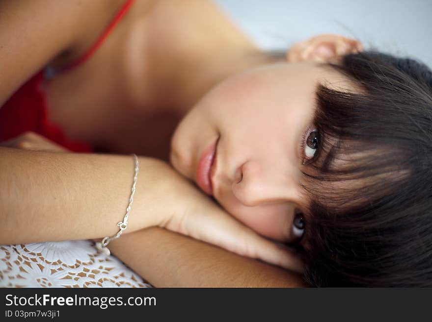 Closeup portrait of a beautiful young woman lying. Closeup portrait of a beautiful young woman lying