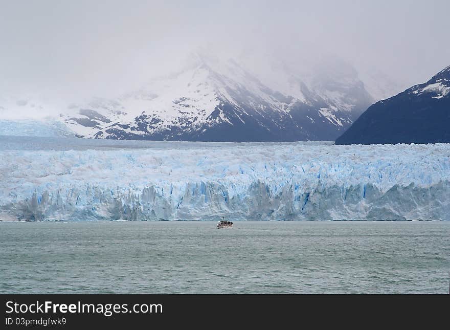 A boat is navigating to the occidental side of the perito moreno glacier. A boat is navigating to the occidental side of the perito moreno glacier