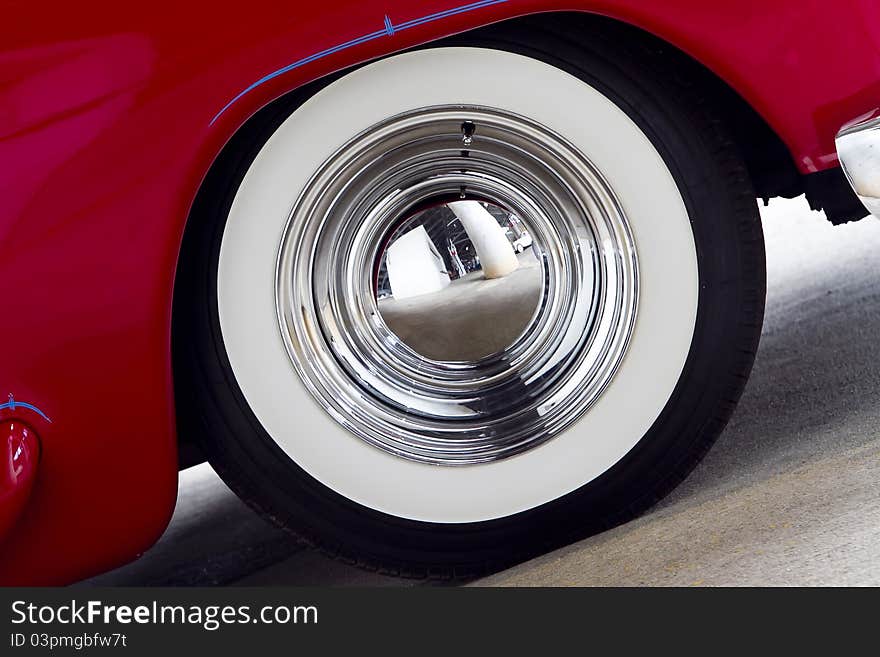 White wall tire on a red classic car