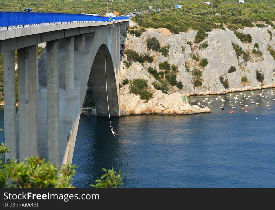 Mountainous landscape crossed by the river, with the extreme sport bungee jumping on the blue bridge, Croatia