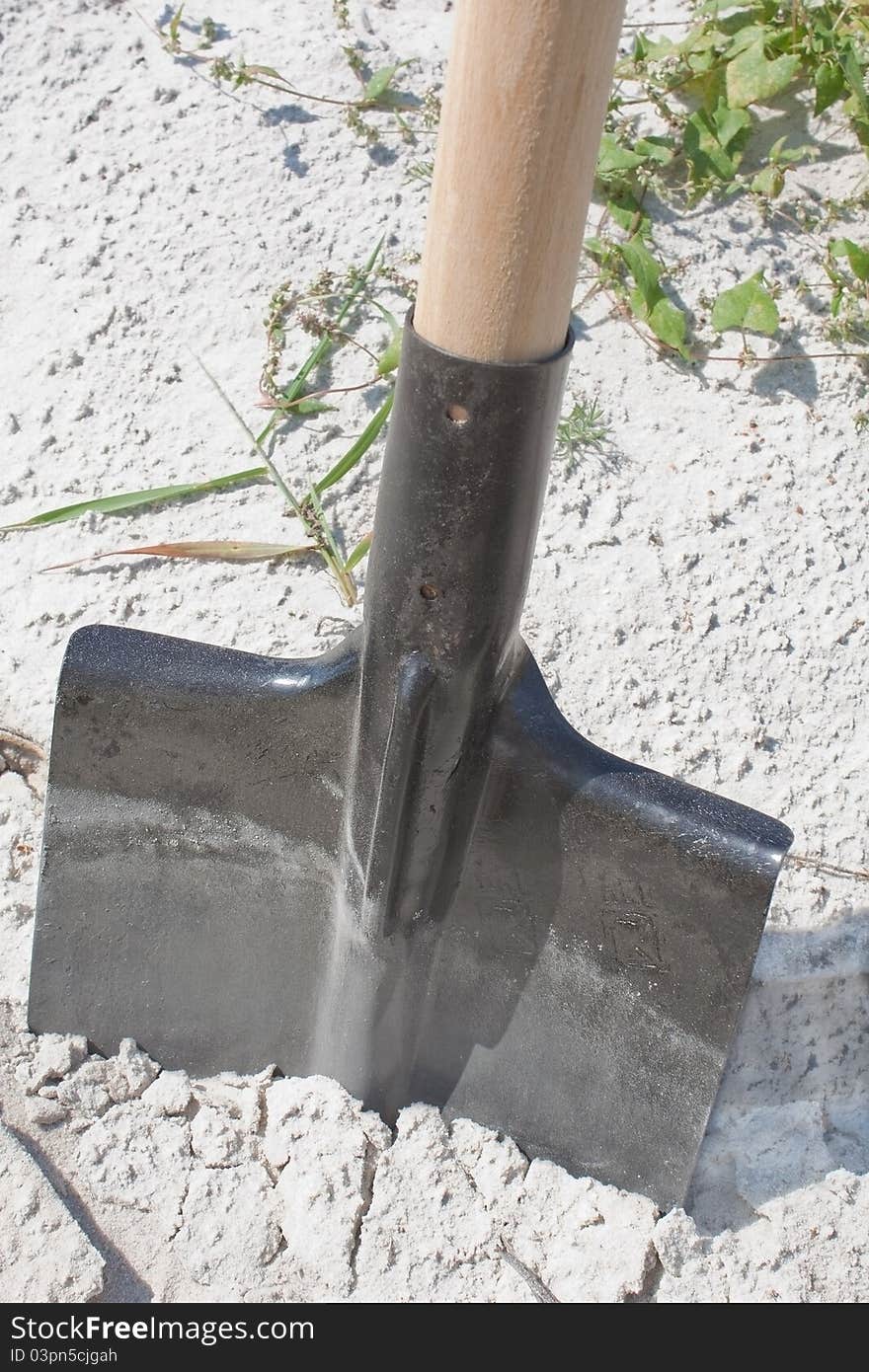 New shovel in a sand, close up