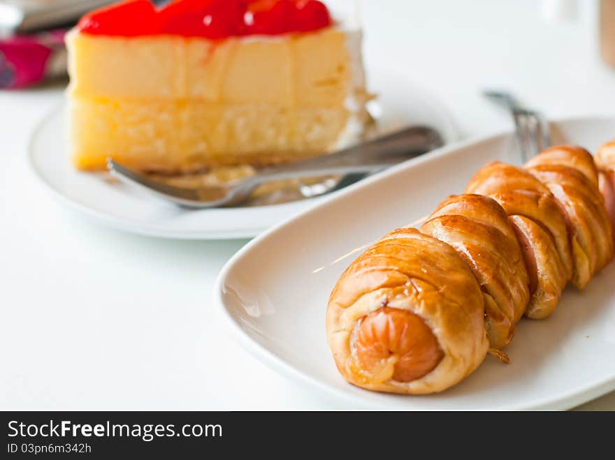 Strawberry Cheesecake and croissant in the coffee shop. Strawberry Cheesecake and croissant in the coffee shop