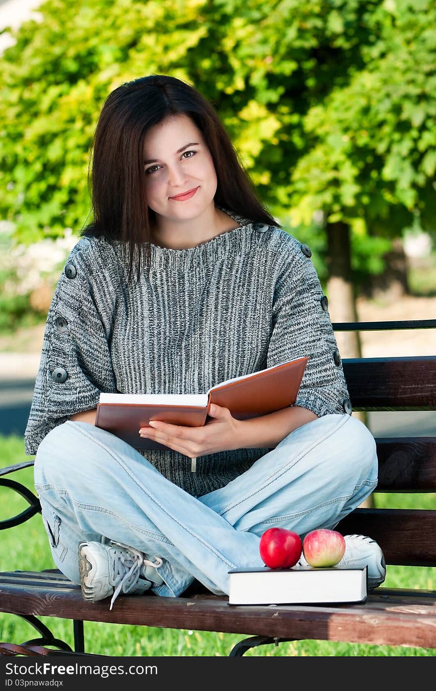 Portrait of a young female student with books at the campus