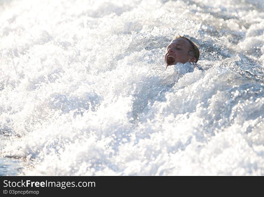 Head of screaming boy above the water