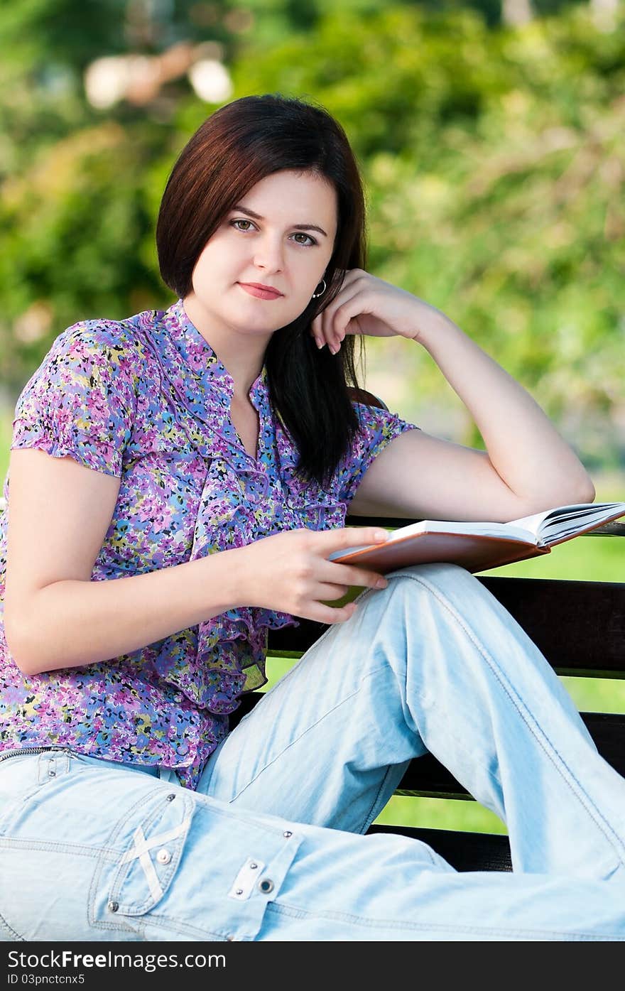 Portrait of a young female student with books at the campus