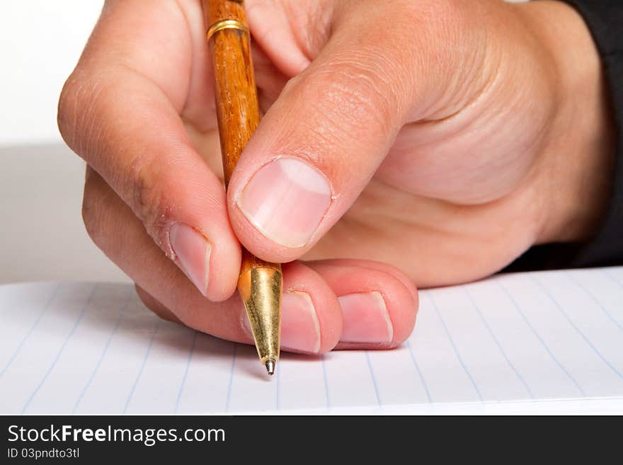 A close up of a man writing in a notebook. A close up of a man writing in a notebook