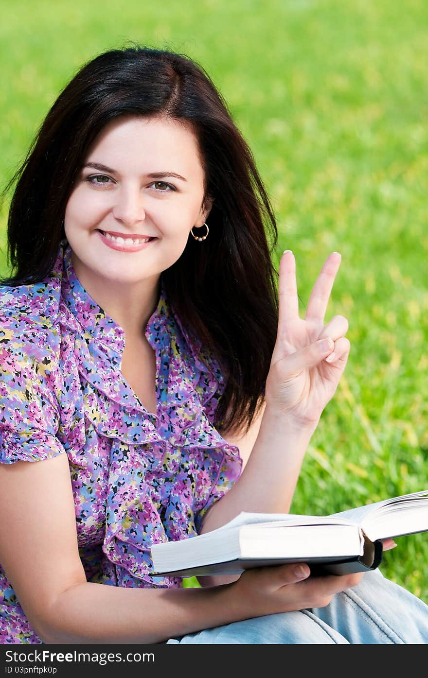 Portrait of a young female student with books at the campus