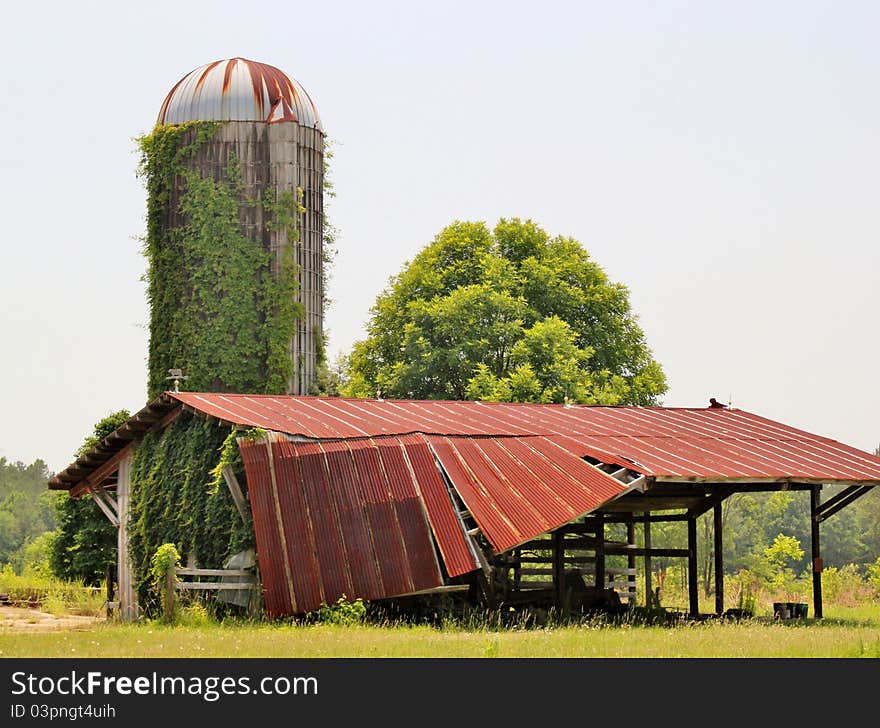 A Dilapidated Old Barn And Silo