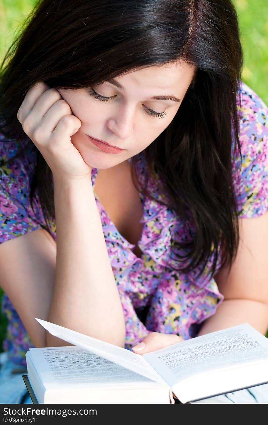 Portrait of a young female student with books at the campus