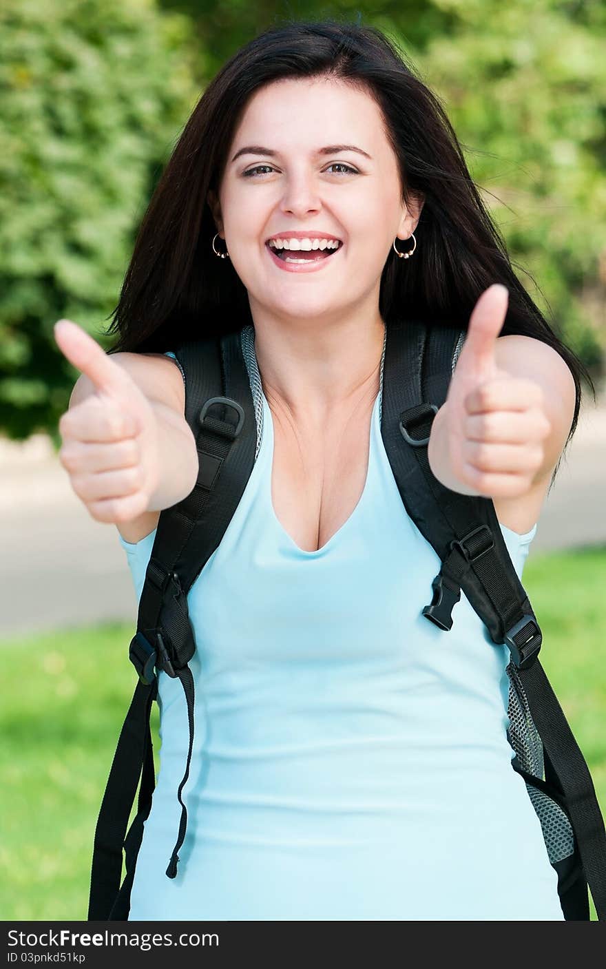 Portrait of a young female student with bag at the campus