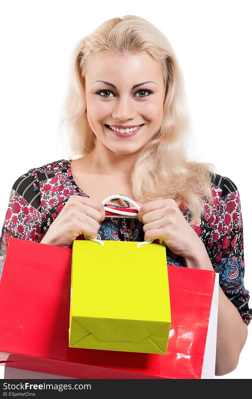 Portrait of a young woman holding a shopping bags over white background. Portrait of a young woman holding a shopping bags over white background