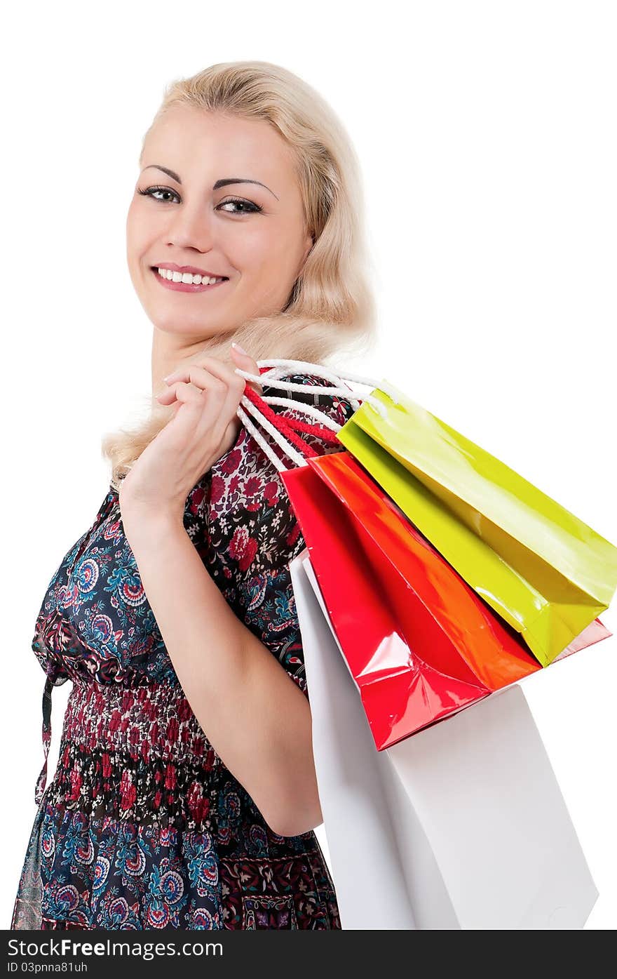 Portrait of a young woman holding a shopping bags over white background. Portrait of a young woman holding a shopping bags over white background