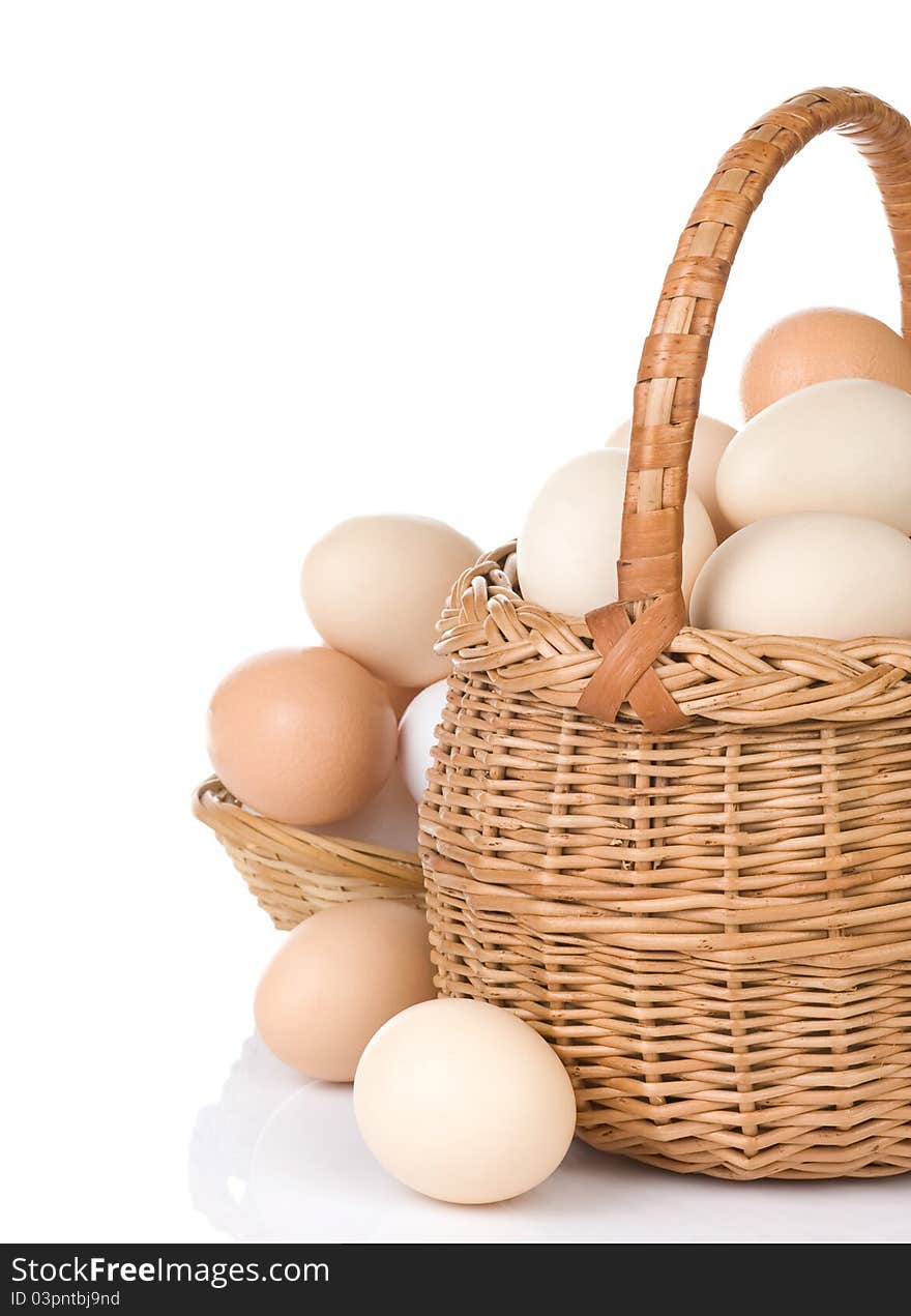 Eggs and basket on white background