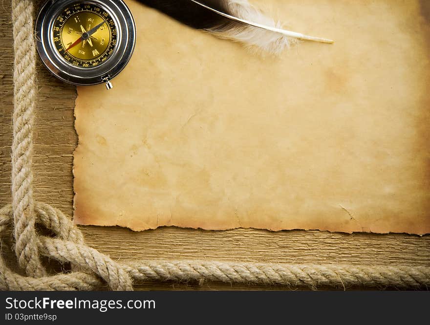 Parchment paper and feather with rope on wood