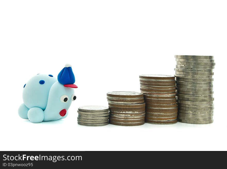 Heap of coins and plasticine turtle for financial planning concept. Heap of coins and plasticine turtle for financial planning concept