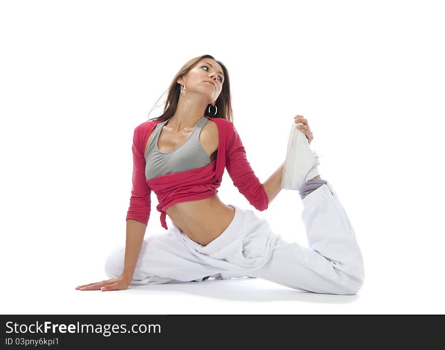 Pretty flexible dancer woman stretching and getting ready to dance on a white background