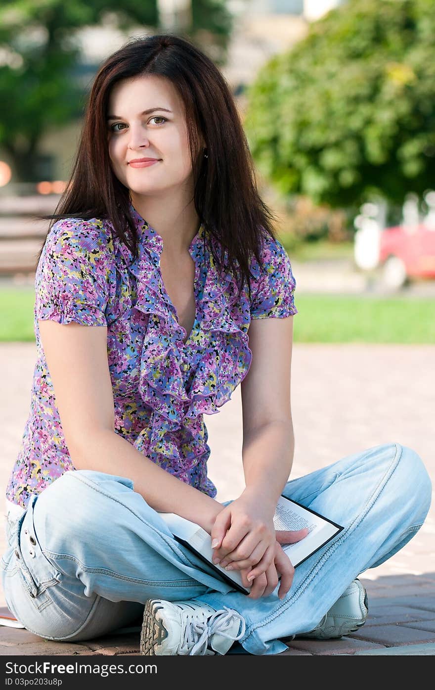 Portrait of a young female student with books at the campus