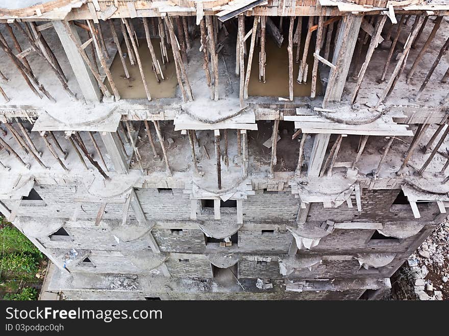 Construction of a hotel at a middle stage with bamboo stick supporting higher levels of the structure. Construction of a hotel at a middle stage with bamboo stick supporting higher levels of the structure.