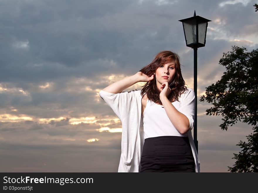 Woman at sunset, sub beams as background