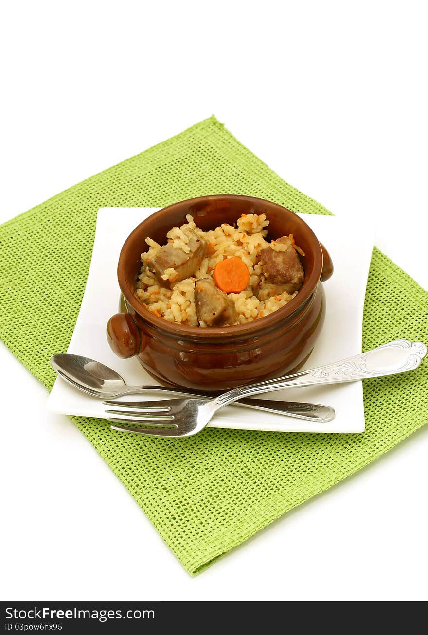 Rice with meat in a ceramic bowl isolated on white background