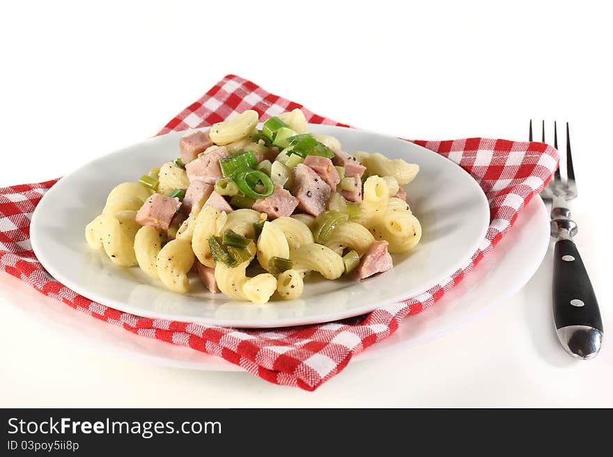 A white plate of Munich ham pasta