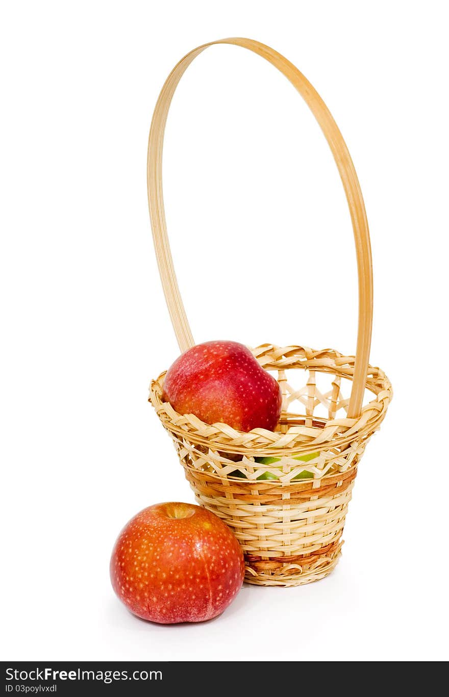 Wicker basket with apples, white background, isolated