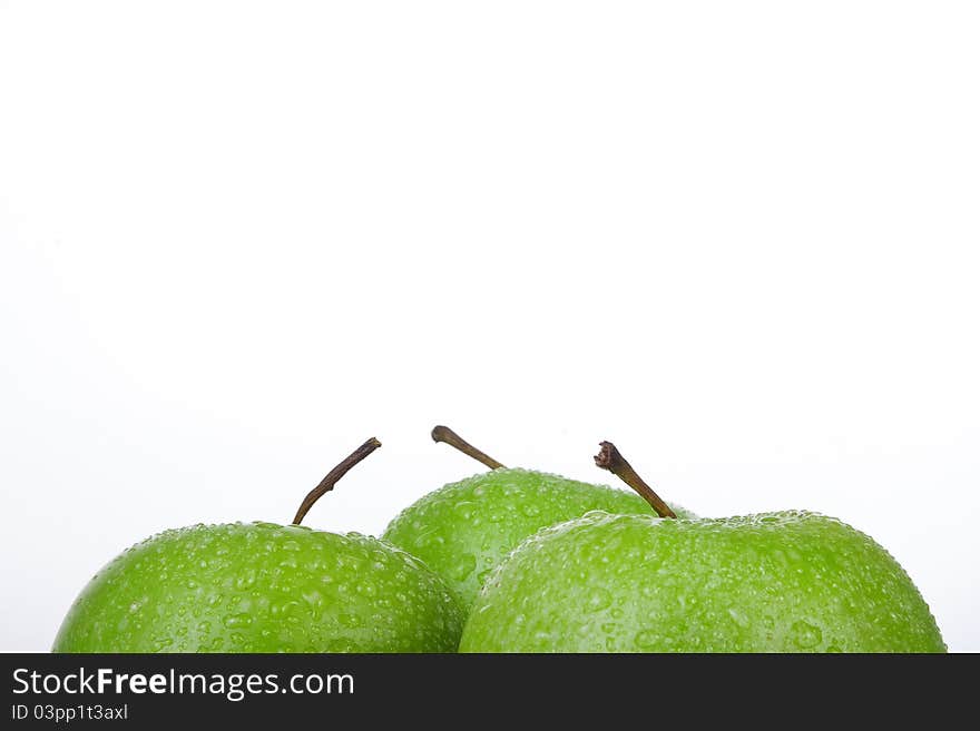 Frame of fresh Green Apple with water droplets against a white background