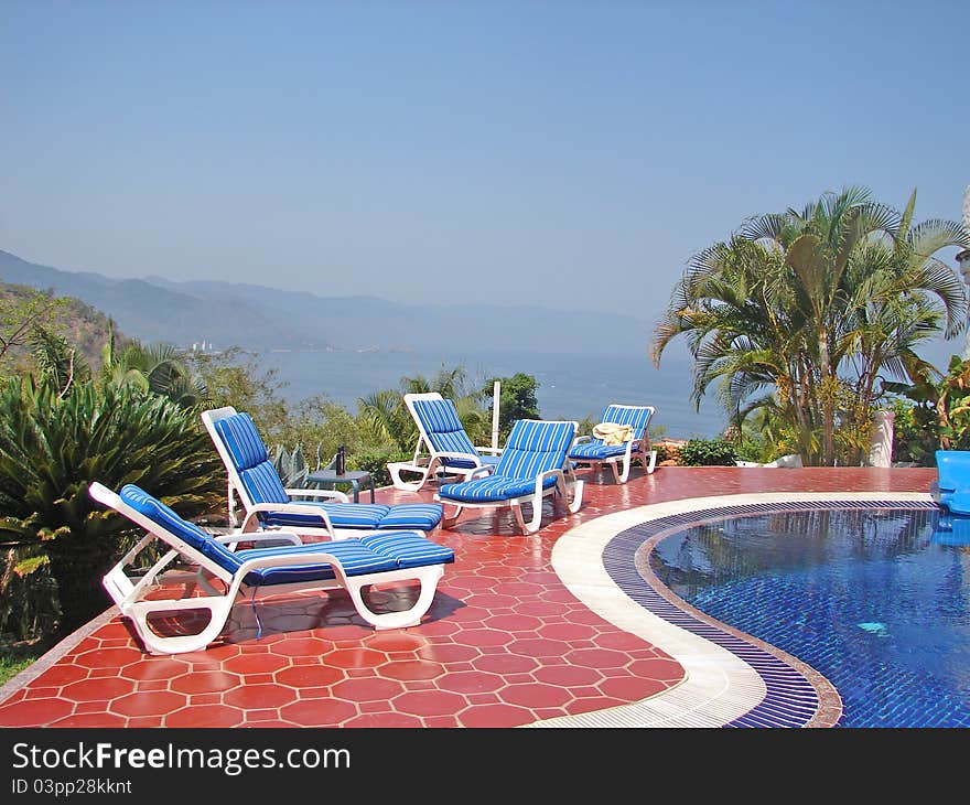 View of puerto vallarta ocean poolside with beach chairs. View of puerto vallarta ocean poolside with beach chairs