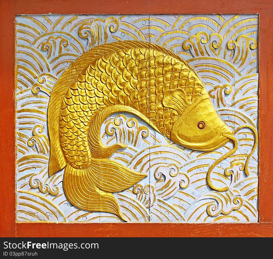 Gold fish wood texture carving background. Gold fish wood texture carving background