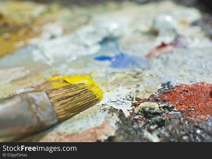 Close-up image of a color palette with yellow color brush